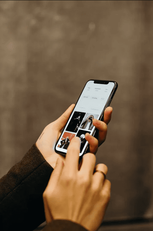 A person using a mobile device with both hands. 