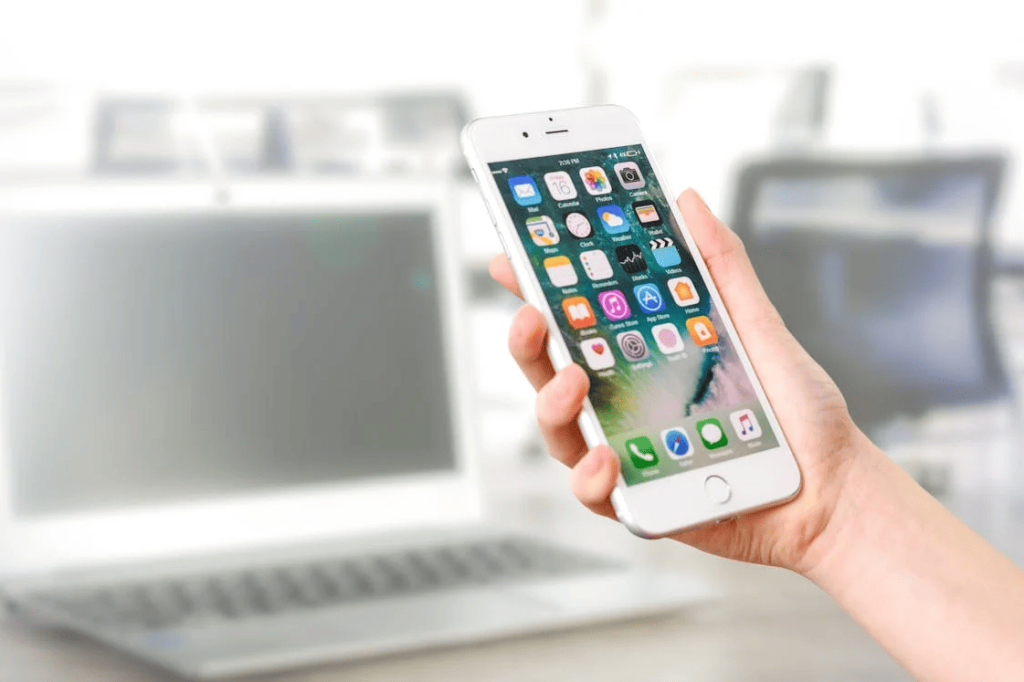 A person holding a white Android mobile device. 