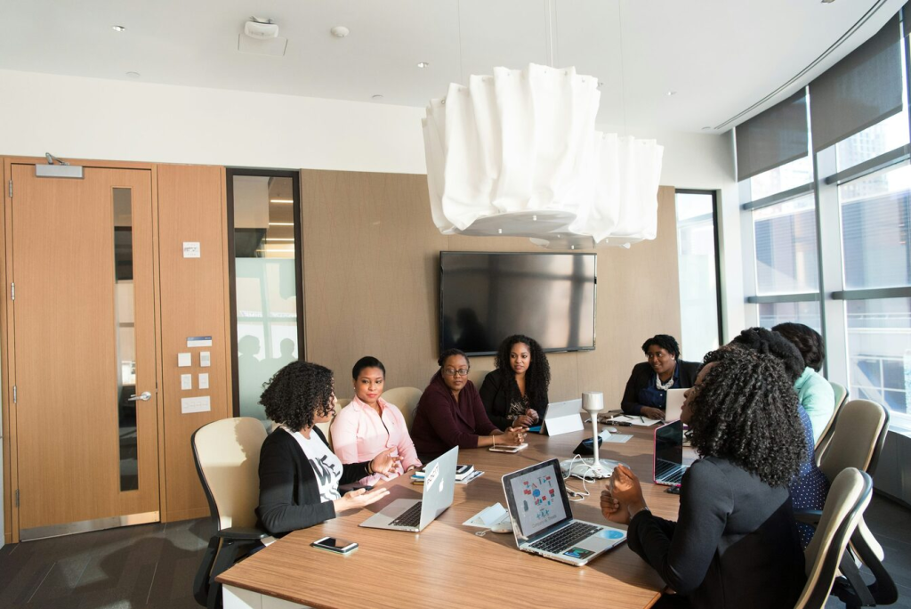 A group of people sitting around a table and talking.