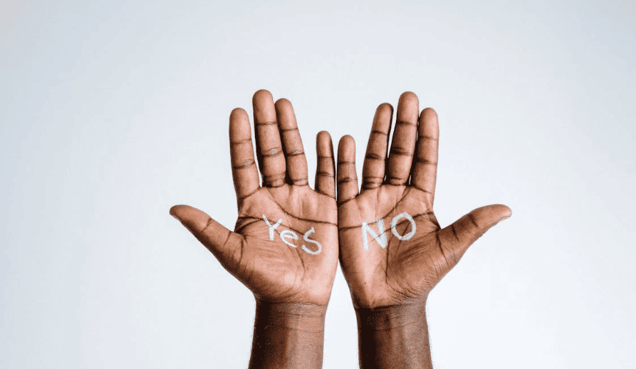 A pair of hands showing the words "yes and "no."