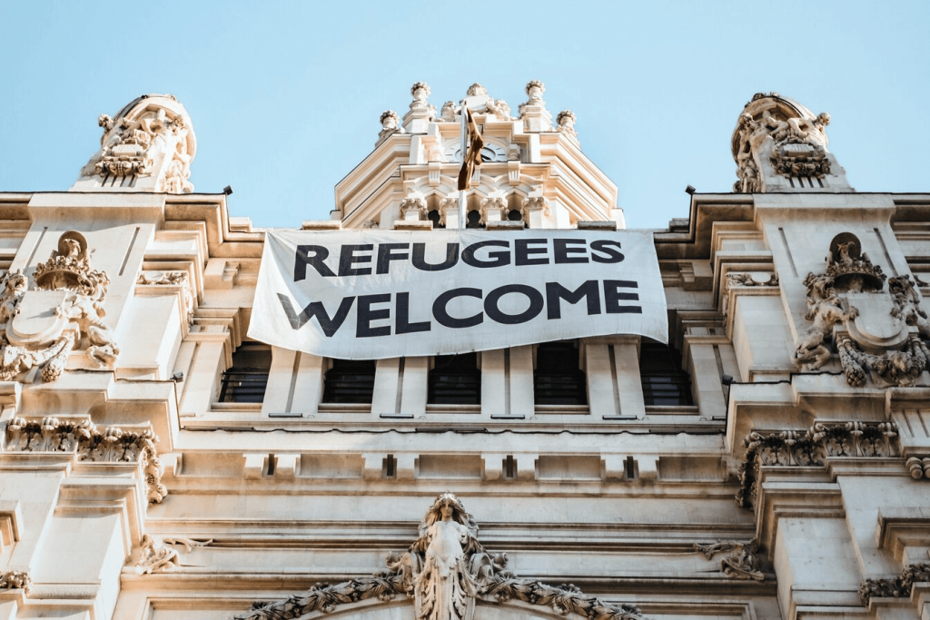 A sign on a building that says "refugees welcome."