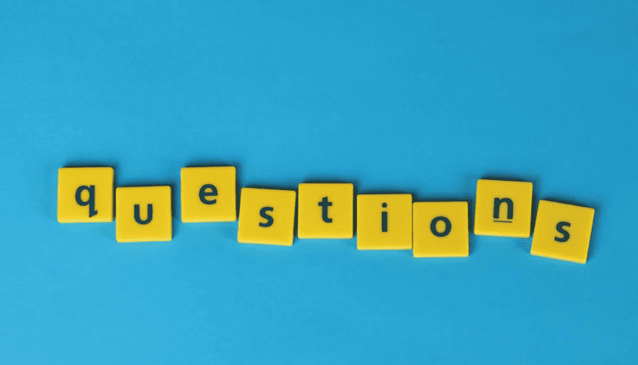 The word "questions" in yellow tiles with a light blue background. 