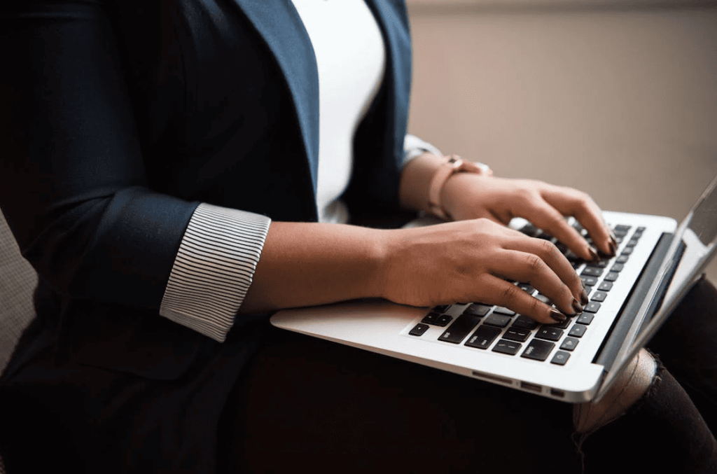 A person typing on a laptop. 