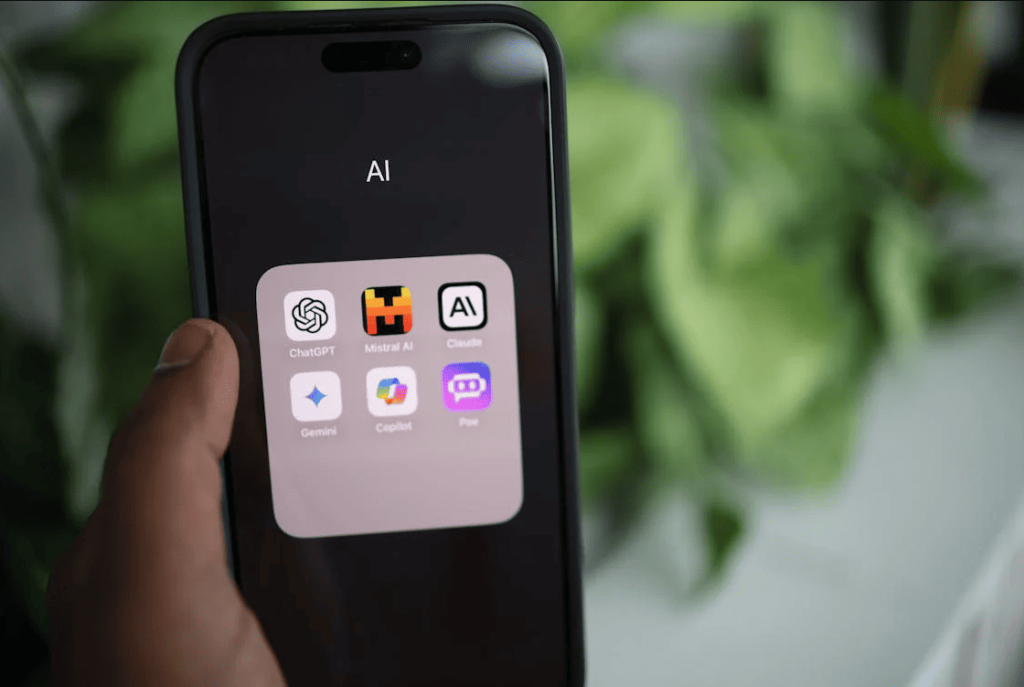 A person holding a smartphone that's showing AI apps. 