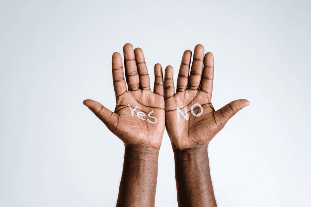 Hands with the words yes and no written on the palms. 