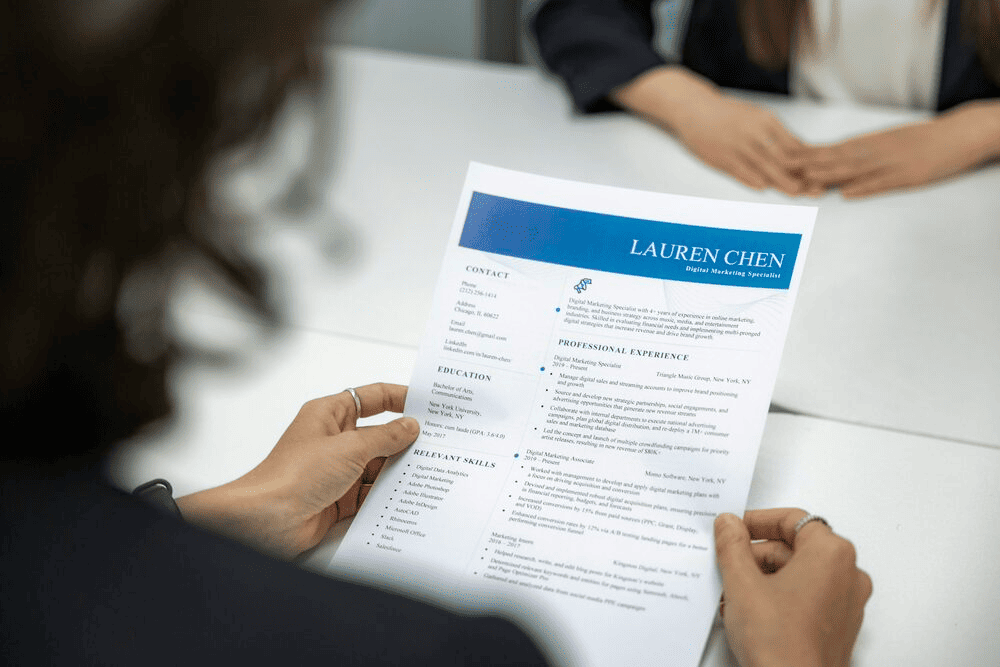 A woman reading someone's resume.