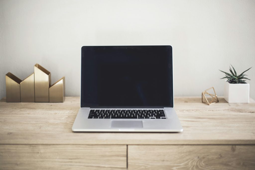 A MacBook Pro on top of a brown table.